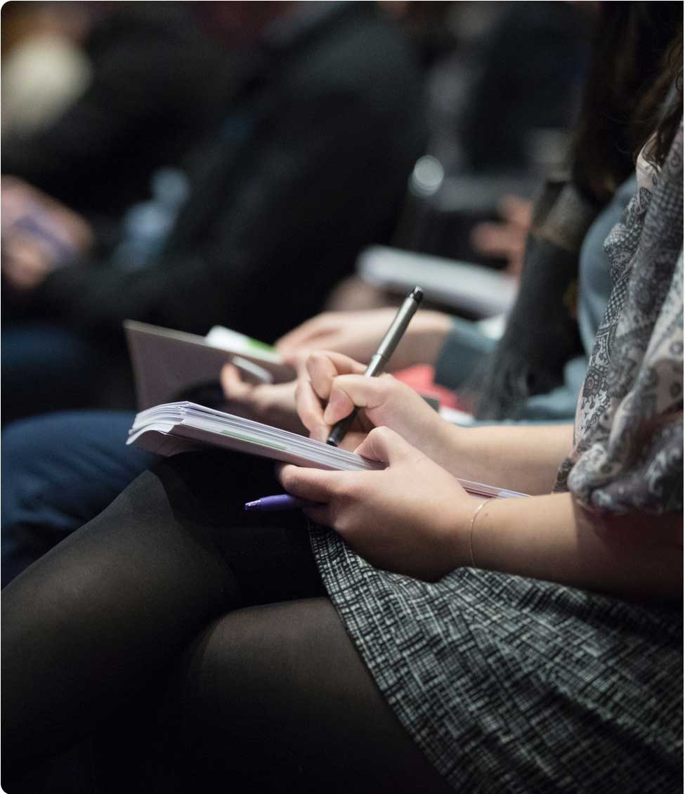 Student taking notes during a class