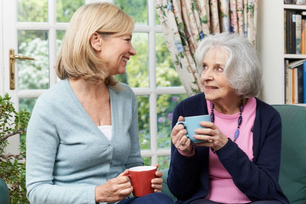 Woman having tea with her senior