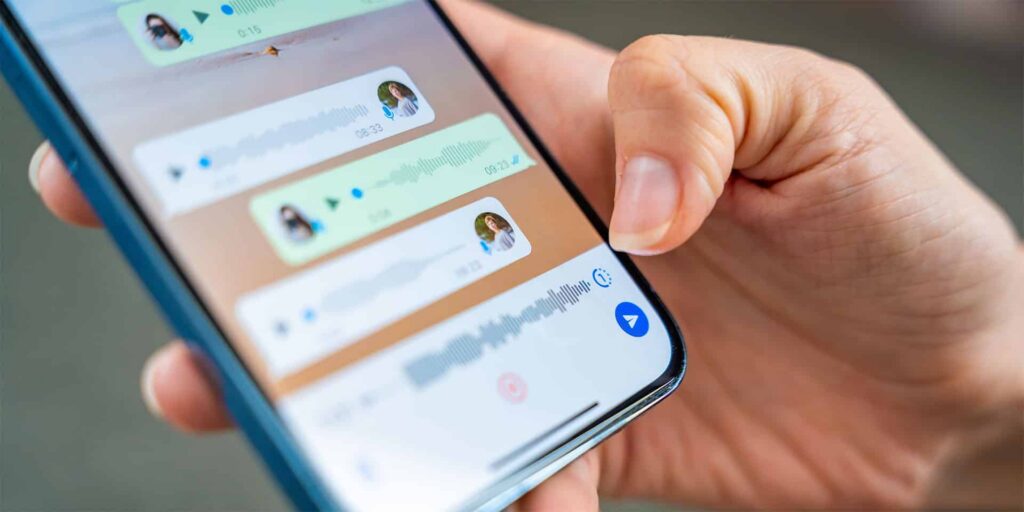 person holding a phone and in a group chat that may be a scam